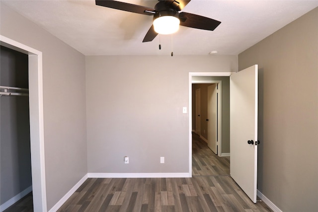 unfurnished bedroom with ceiling fan, a closet, and dark hardwood / wood-style floors