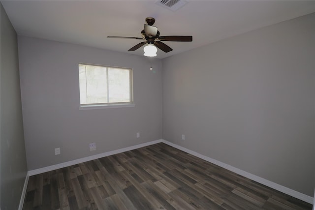 spare room featuring ceiling fan and dark hardwood / wood-style floors