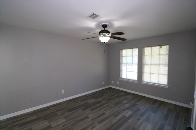 spare room featuring ceiling fan and dark wood-type flooring