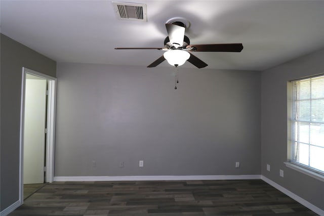 spare room with ceiling fan, dark hardwood / wood-style flooring, and plenty of natural light