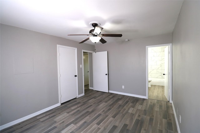 unfurnished bedroom with ceiling fan, a closet, dark hardwood / wood-style floors, and connected bathroom