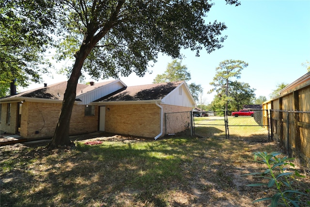 view of side of home with a yard