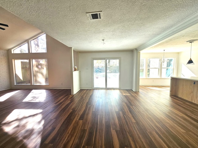 unfurnished living room featuring ceiling fan with notable chandelier and dark hardwood / wood-style floors