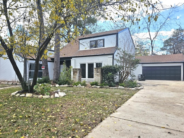 view of front of property with a garage and a front lawn