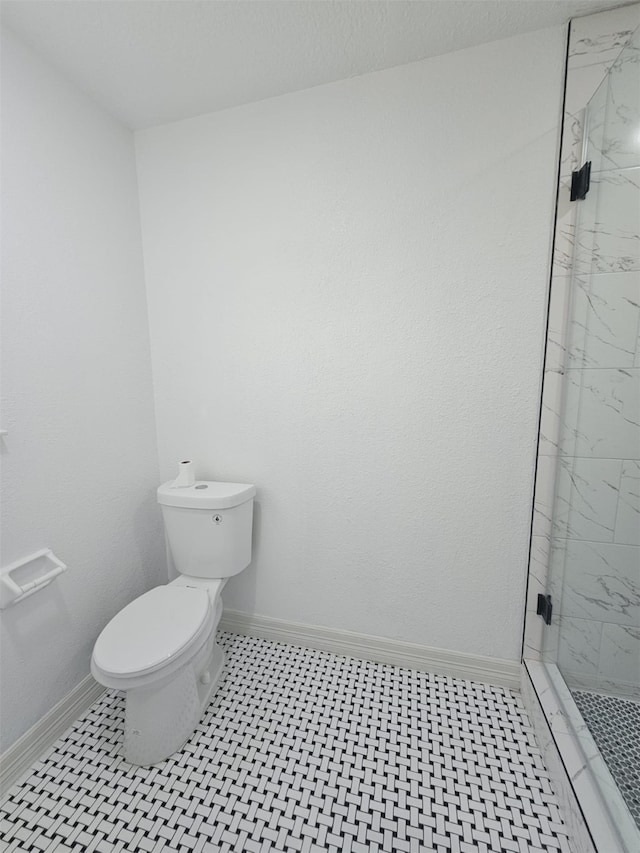 bathroom featuring toilet and walk in shower