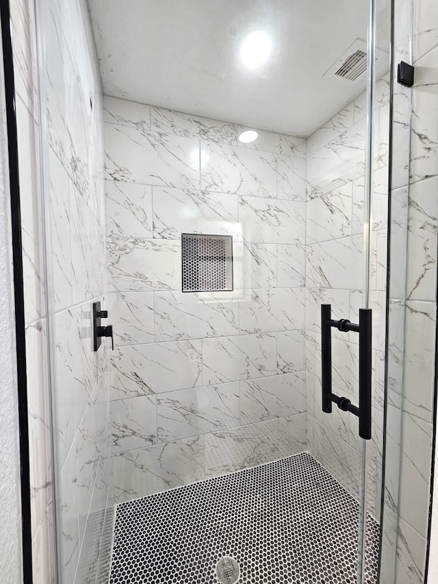 bathroom with a shower with door