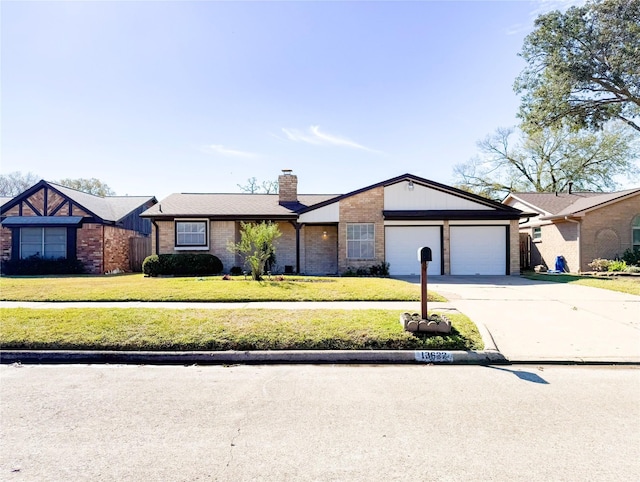 view of front of home with a garage, concrete driveway, brick siding, and a front lawn