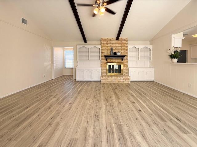 unfurnished living room with ceiling fan, lofted ceiling with beams, a fireplace, and light hardwood / wood-style flooring