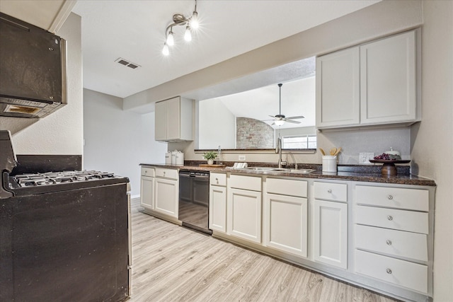 kitchen featuring sink, light hardwood / wood-style flooring, white cabinets, and black appliances