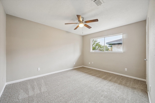 spare room featuring a textured ceiling, ceiling fan, and carpet floors