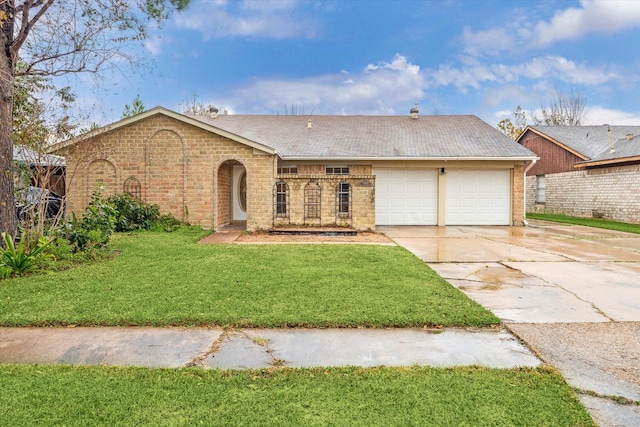 ranch-style home featuring a garage and a front lawn