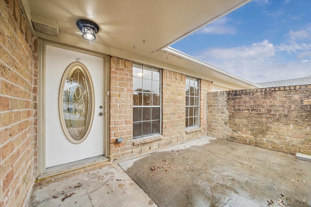 entrance to property with a patio