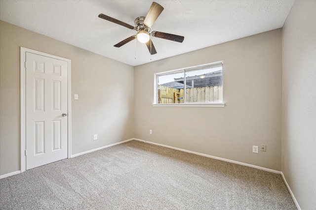 spare room with ceiling fan and carpet flooring