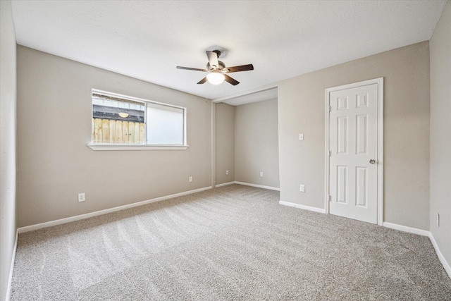 carpeted empty room with ceiling fan