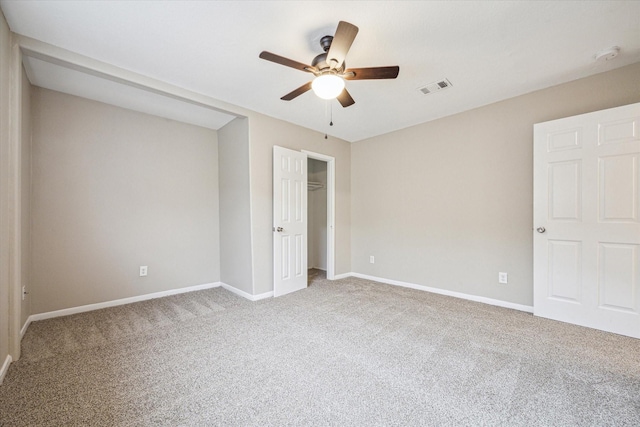 unfurnished bedroom featuring ceiling fan, a closet, and carpet