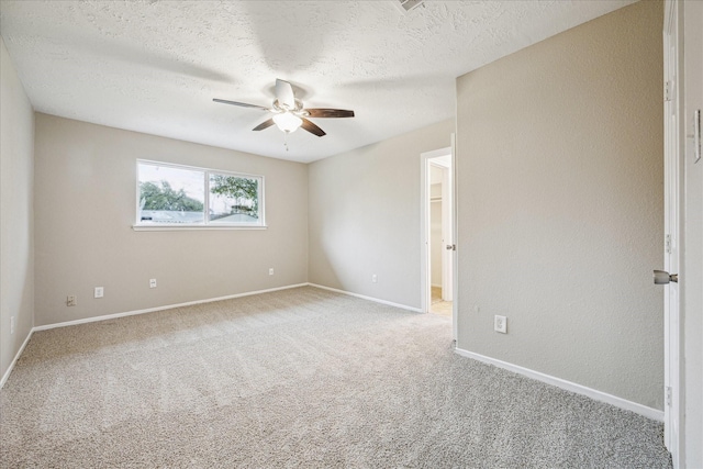 unfurnished room featuring carpet floors, ceiling fan, and a textured ceiling