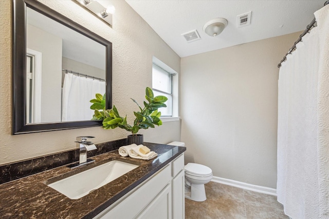 bathroom featuring toilet and vanity