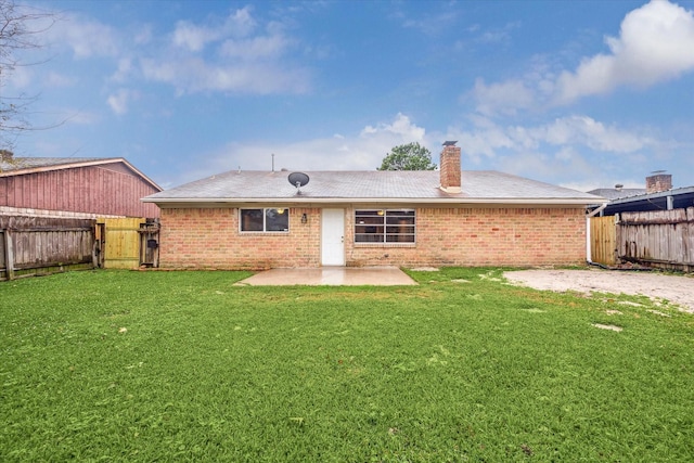 rear view of house with a lawn and a patio area