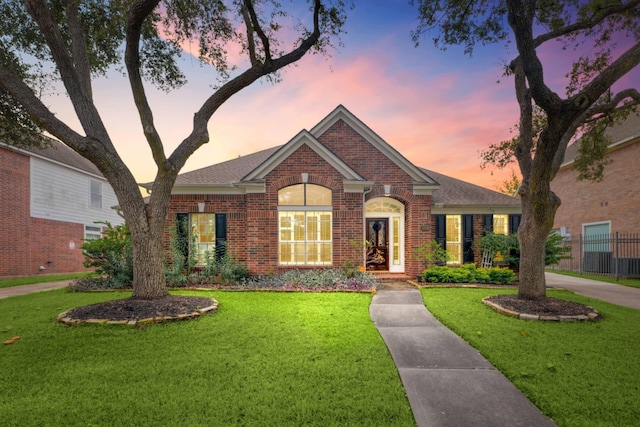 ranch-style home with a lawn