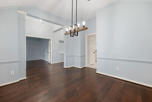 unfurnished room with dark hardwood / wood-style floors, crown molding, and vaulted ceiling