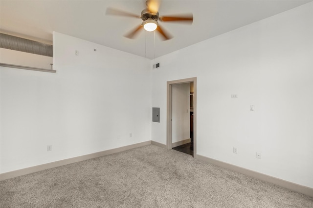 empty room featuring ceiling fan and light carpet