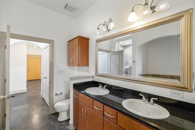 bathroom featuring toilet and vanity