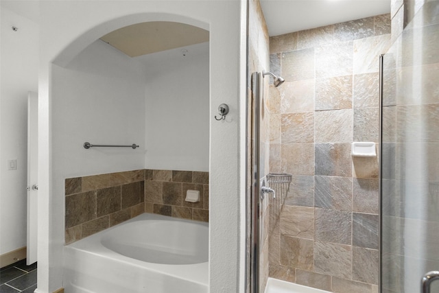 bathroom with tile patterned floors and separate shower and tub