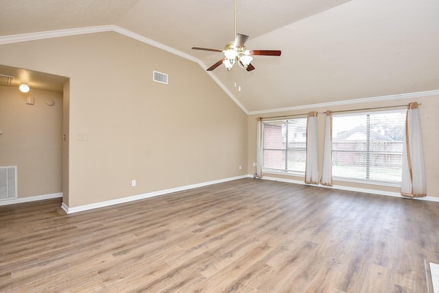 unfurnished room featuring ceiling fan, light wood-type flooring, crown molding, and vaulted ceiling