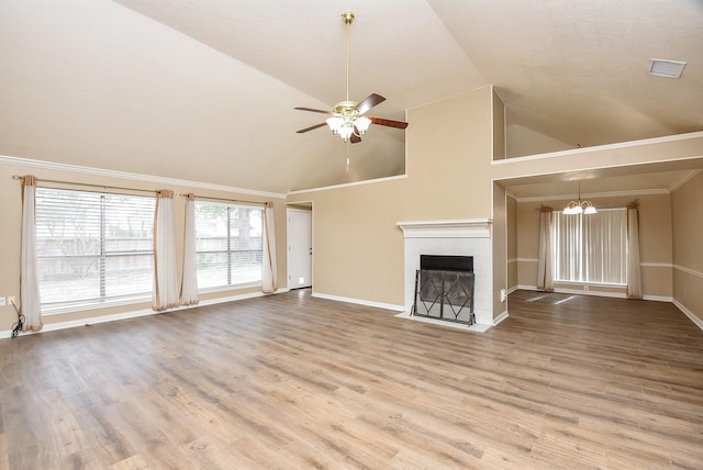 unfurnished living room featuring hardwood / wood-style flooring, lofted ceiling, and ceiling fan with notable chandelier