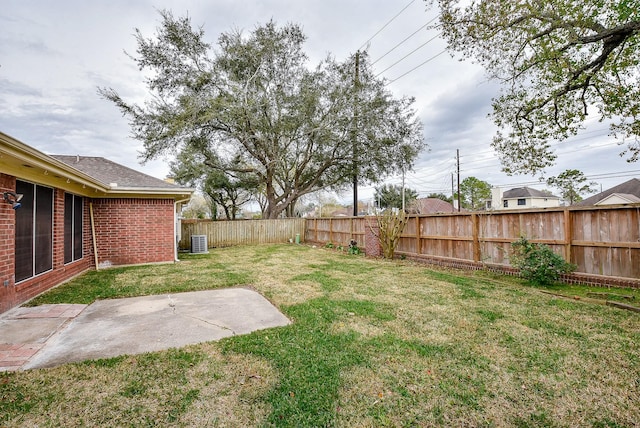 view of yard with cooling unit and a patio