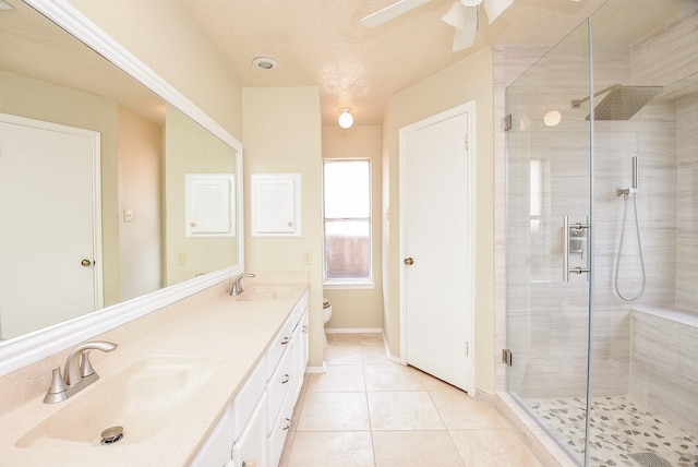 bathroom featuring toilet, an enclosed shower, tile patterned floors, vanity, and ceiling fan