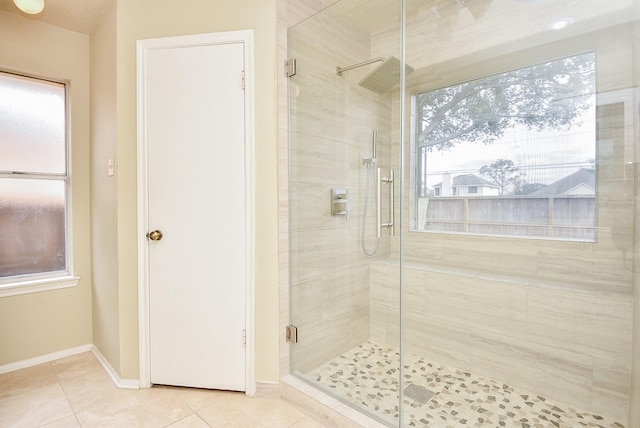 bathroom with tile patterned flooring and a shower with shower door