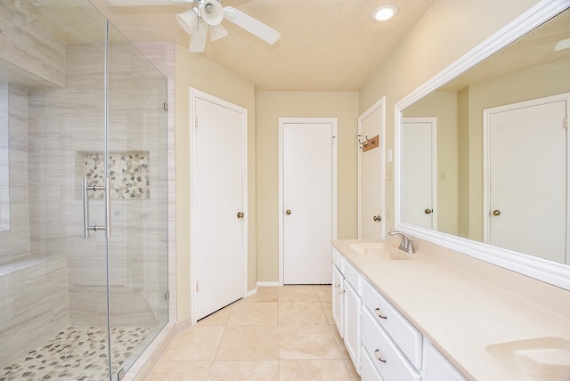 bathroom with ceiling fan, an enclosed shower, tile patterned floors, and vanity