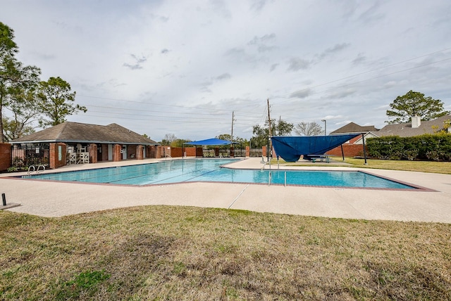 view of swimming pool featuring a lawn and a patio