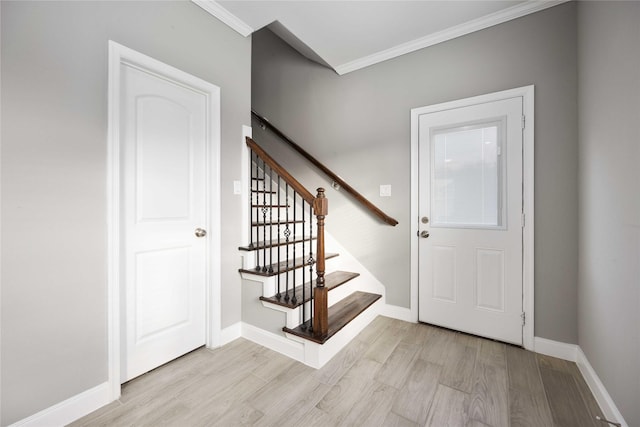 entryway featuring light wood-type flooring and ornamental molding