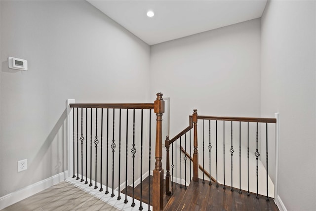 stairs featuring wood-type flooring