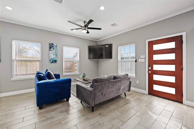 living room with ceiling fan and ornamental molding