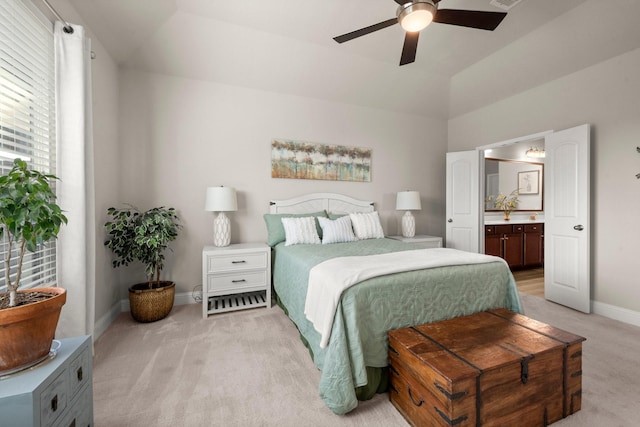 carpeted bedroom featuring ceiling fan, connected bathroom, and lofted ceiling