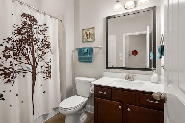 bathroom featuring toilet, a shower with curtain, and vanity