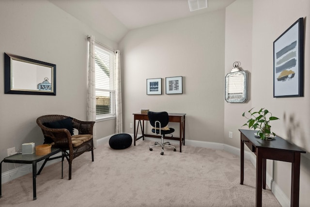 carpeted office space featuring vaulted ceiling