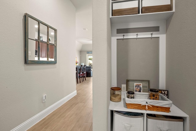 hallway with light hardwood / wood-style floors