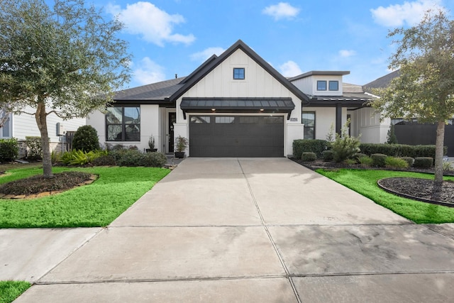 view of front of house with a garage and a front yard