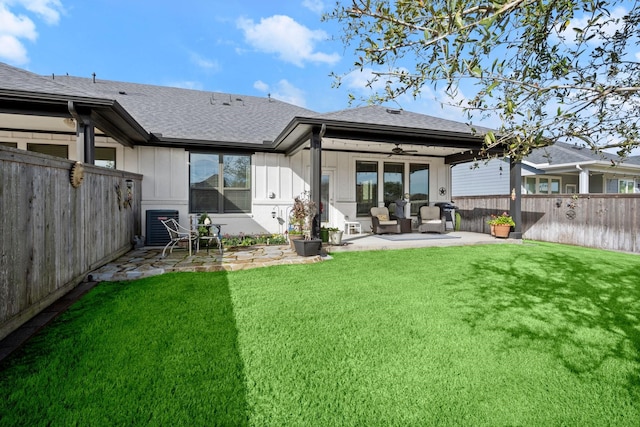 back of house featuring ceiling fan, central AC, a lawn, and a patio