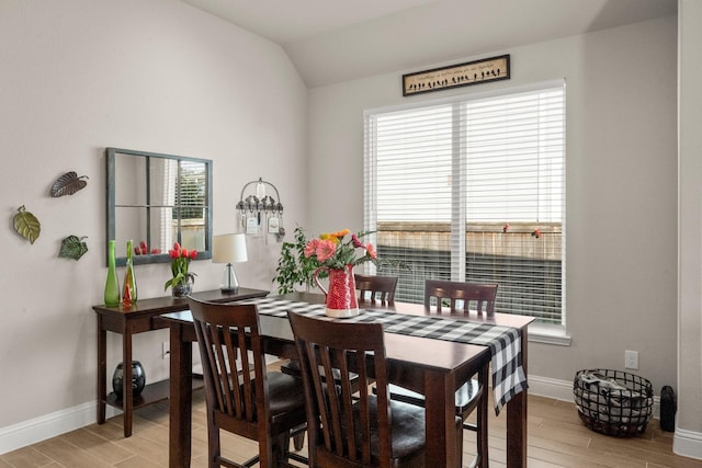 dining room featuring lofted ceiling and plenty of natural light