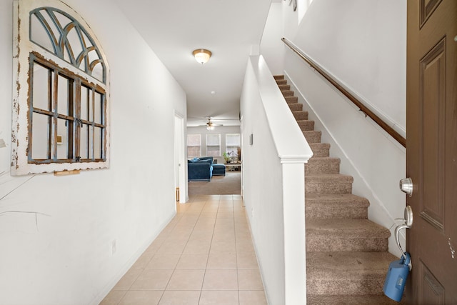 entrance foyer with ceiling fan and light tile patterned floors