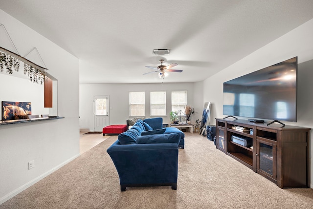 carpeted living room featuring ceiling fan