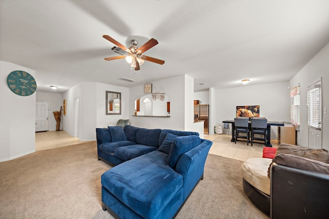 tiled living room with ceiling fan