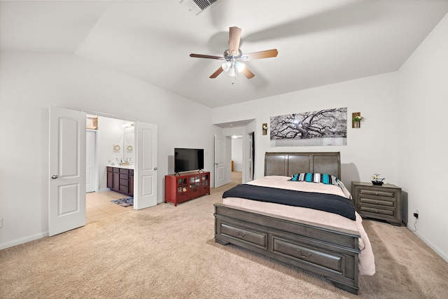 carpeted bedroom with ceiling fan, ensuite bathroom, and lofted ceiling