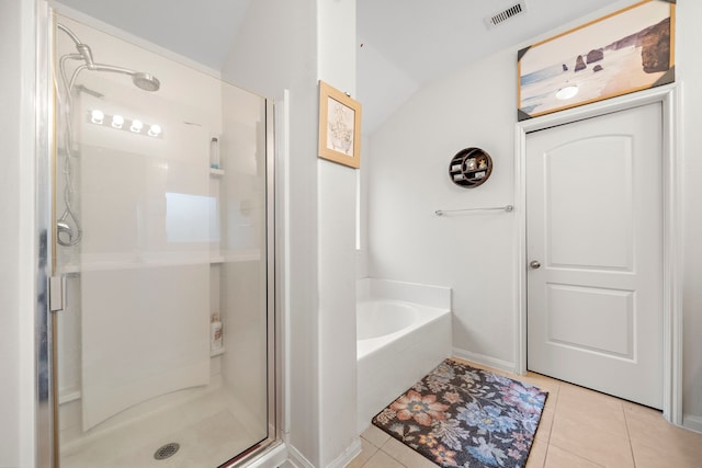 bathroom with separate shower and tub, vaulted ceiling, and tile patterned floors