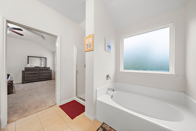 bathroom featuring ceiling fan, vaulted ceiling, tile patterned floors, and independent shower and bath